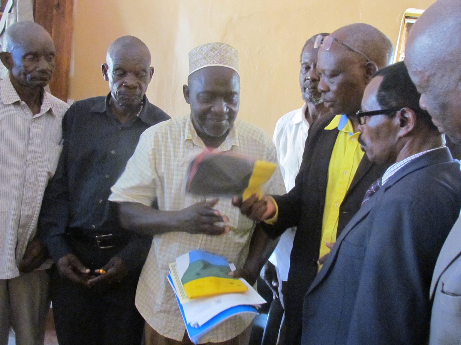 Members of the elders Sacco admiring their certificate which was recently given to them.