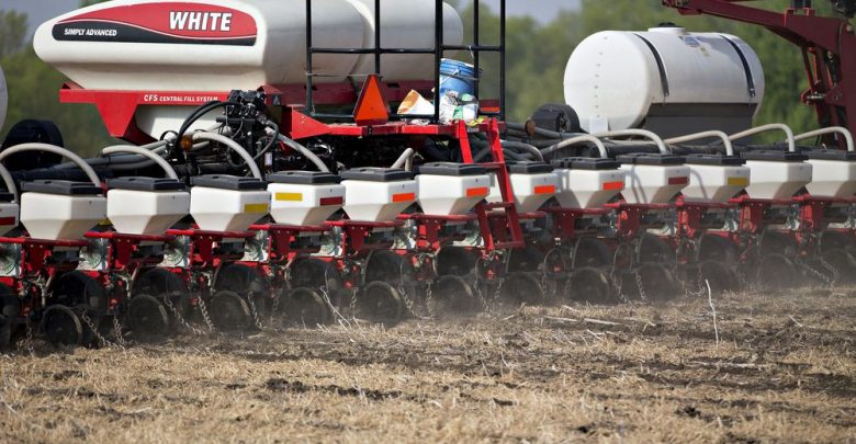 An AGCO Corp. White planter machine moves through a field as corn is planted in Princeton, Illinois. Photographer: Daniel Acker/Bloomberg